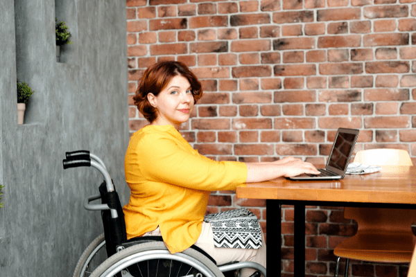 jeunne femme en situation de handicap devant un ordinateur à l'école